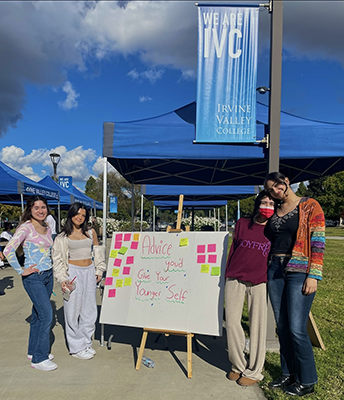 Students standing next to micro-affirmation board 