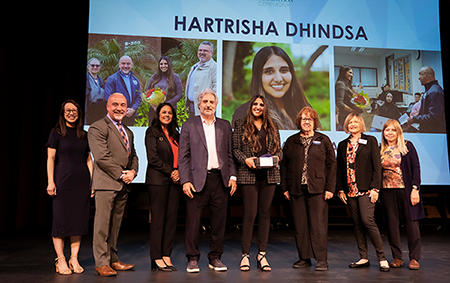 Hartrisha Dhindsa receiving award 