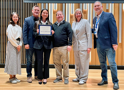 Idea Pitch winner with judges panel 