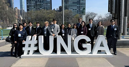 students posing in front of #UNGA sign 