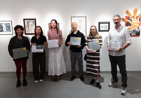 students holding awards at Student Art Exhibition 