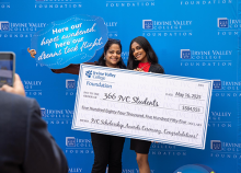 Scholarship recipients holding large check