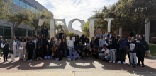 Students posed as a group in front of outdoor TSU monument sign 